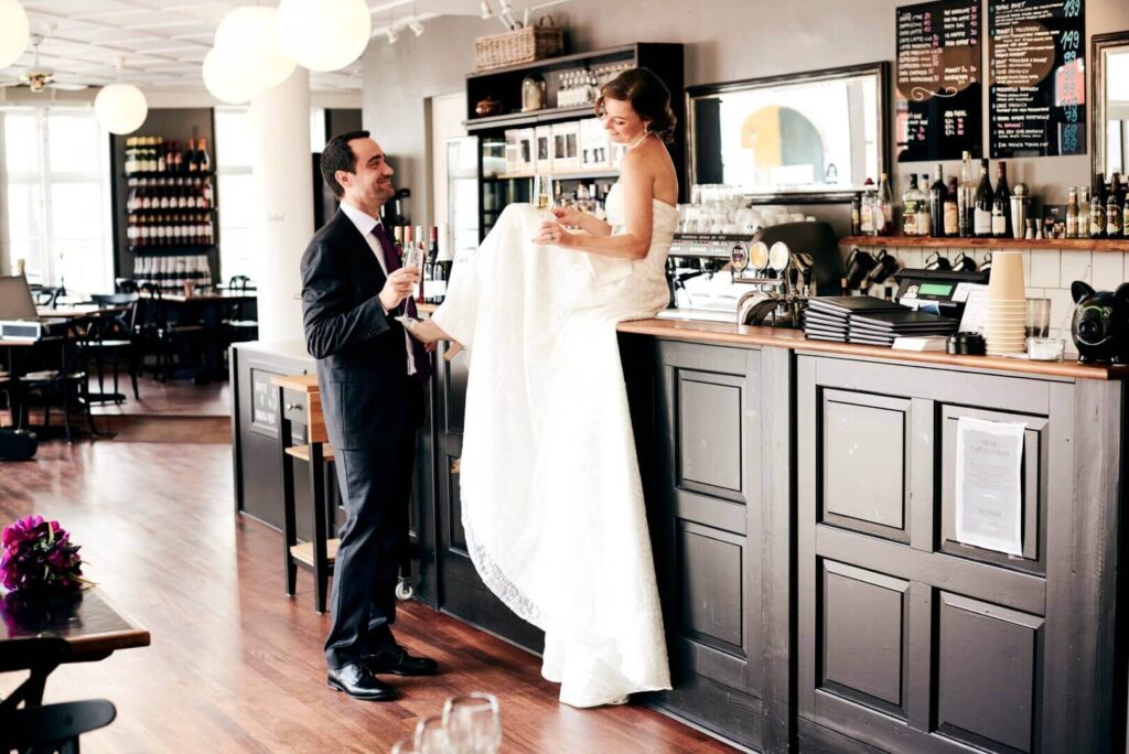 Bride and groom celebrating their wedding with champagne in our café at På Torvet in Ærøskøbing.